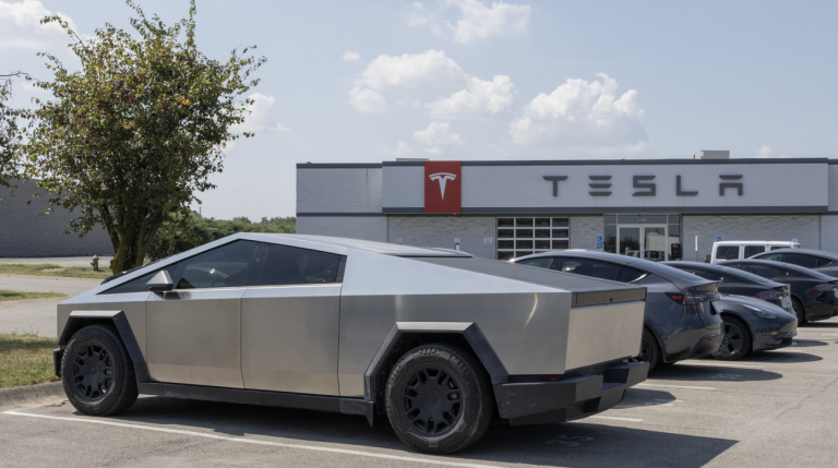 tesla cybertruck parked next to a Tesla dealership